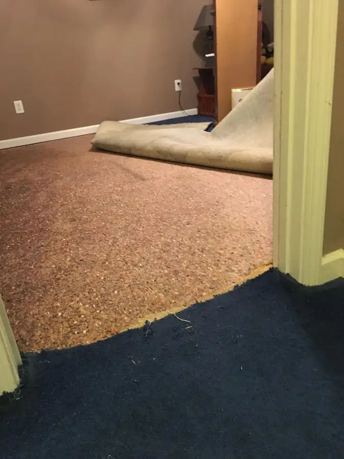 Carpet pad removal revealing water damage during Drying & Dehumidification in Diboll
